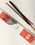 Back of a Clemeno White Tiger incense box with incense sticks on a white surface