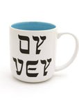 White mug with black Hebrew text and blue interior on a white background