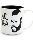 White mug with black interior, black and white graphic of a face, and 'MR. TEA' text on a white background
