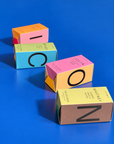 Icons perfume boxes laid out to spell ICON on a blue background