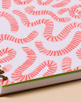 Unlock your inner child with this delightfully wiggly worm notebook. Featuring a quirky worm pattern on a letterpress printed cover, this A5 spiral notebook is just the right size for lists, doodles, and garden daydreams.