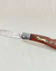 Wooden Cheetah Pocket Knife with a Damascus steel blade and brass cheetah inlay in the wood handle