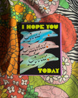 Colorful fabric with a motivational card featuring dolphins and text.