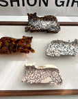 Add a touch of wild style to your hair with this leopard-print claw clip. Made from smooth acetate, it’s lightweight yet strong, keeping your hair secure while adding a bold, playful pattern to any look. Perfect for animal print lovers or anyone looking to make a stylish statement.