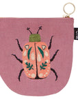 Secure your small valuables in the Amulet Halfmoon Pouch. Featuring a scarab beetle design on deep musky pink, perfect for keys, cards, and loose coins.