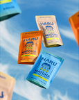 Three packages of HARU Matcha Oat Milk Latte on a blue background