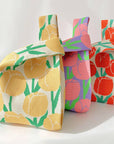 Orange tulip knit bag beside a yellow floral knit bag