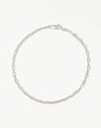 Sterling silver chain bracelet laid in a circle on white