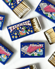 Fishwife Limited-Edition Matchbox. Cozy winter vibes by the fire with art by Danny “Danbo” Miller. Light up your home, Fishwife-style!