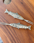 These Pewter Salmon Hors d'Oeuvre Picks are perfect for grabbing olives, pickles, and other hors d'oeuvres. Perfect for fish lovers and nature enthusiasts! Add a touch of playfulness to your kitchen or charcuterie board. Get ready to reel in those compliments. Fine hand-crafted pewter and stainless steel, made in Canada.