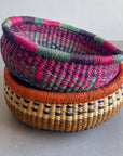 Decorate your home with a Round Bolga Basket, handwoven by experienced women in Ghana's Bolgatanga region using locally sourced veta vera grass. Each basket is woven wet and can be re-shaped by adding water. Durable and washable, these baskets are a beautiful and unique addition to your decor. Fun fact: kinkahe is a local name for veta vera grass in Ghana!