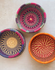 Decorate your home with a Round Bolga Basket, handwoven by experienced women in Ghana's Bolgatanga region using locally sourced veta vera grass. Each basket is woven wet and can be re-shaped by adding water. Durable and washable, these baskets are a beautiful and unique addition to your decor. Fun fact: kinkahe is a local name for veta vera grass in Ghana!