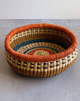 Decorate your home with a Round Bolga Basket, handwoven by experienced women in Ghana's Bolgatanga region using locally sourced veta vera grass. Each basket is woven wet and can be re-shaped by adding water. Durable and washable, these baskets are a beautiful and unique addition to your decor. Fun fact: kinkahe is a local name for veta vera grass in Ghana!