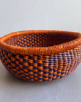 Decorate your home with a Round Bolga Basket, handwoven by experienced women in Ghana's Bolgatanga region using locally sourced veta vera grass. Each basket is woven wet and can be re-shaped by adding water. Durable and washable, these baskets are a beautiful and unique addition to your decor. Fun fact: kinkahe is a local name for veta vera grass in Ghana!