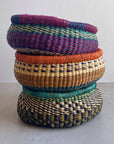 Decorate your home with a Round Bolga Basket, handwoven by experienced women in Ghana's Bolgatanga region using locally sourced veta vera grass. Each basket is woven wet and can be re-shaped by adding water. Durable and washable, these baskets are a beautiful and unique addition to your decor. Fun fact: kinkahe is a local name for veta vera grass in Ghana!