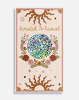 Product packaging with floral design and 'Scratch To Reveal' text on a beige background