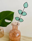 Bring a pop of color and artistry to your home with this handcrafted stained glass gumdrop eucalyptus stem by Samara Designs Studio. This stem is made from beautiful transparent seafoam green stained glass, cut and assembled by hand to create a lasting botanical accent that will never wilt or fade.