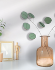 Bring a pop of color and artistry to your home with this handcrafted stained glass silver dollar eucalyptus stem by Samara Designs Studio. This stem is made from beautiful celadon green stained glass, carefully cut and assembled by hand to create a lasting botanical accent that will never wilt or fade.