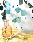 Bring a pop of color and artistry to your home with this handcrafted stained glass silver dollar eucalyptus stem by Samara Designs Studio. This stem is made from beautiful celadon green stained glass, carefully cut and assembled by hand to create a lasting botanical accent that will never wilt or fade.