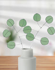 Bring a pop of color and artistry to your home with this handcrafted stained glass silver dollar eucalyptus stem by Samara Designs Studio. This stem is made from beautiful celadon green stained glass, carefully cut and assembled by hand to create a lasting botanical accent that will never wilt or fade.