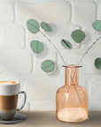 Bring a pop of color and artistry to your home with this handcrafted stained glass silver dollar eucalyptus stem by Samara Designs Studio. This stem is made from beautiful celadon green stained glass, carefully cut and assembled by hand to create a lasting botanical accent that will never wilt or fade.