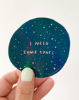 Give me some (literal) space okay? This holographic sticker for the overstimulated reads, "I Need Some Space." Featuring original artwork by Meghan Hopkins Sokorai, this durable, waterproof sticker is dishwasher safe and perfect for laptops, water bottles, notebooks, or anywhere you want to set boundaries with a little sparkle.