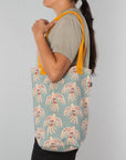 Lightweight and sturdy, this Plume Studio Tote by Danica Studio features reinforced handles and a bold feather design inspired by nature's beauty.