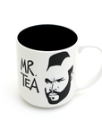 White mug with black interior, featuring a graphic of a face and 'MR. TEA' text on a white background.