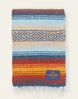 Falsa blanket in light blue, navy, orange and cream stripes with a diamond band