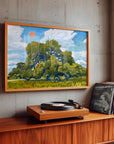 Live oak art print in a wood frame on a concrete wall above a console with a turntable and records