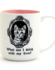 White mug with pink interior, cat illustration, and text on a white background