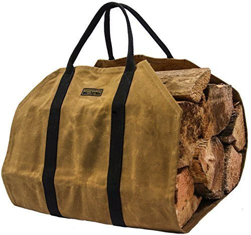 Tan waxed canvas firewood carrier full of split logs on a white background