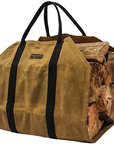 Tan waxed canvas firewood carrier full of split logs on a white background