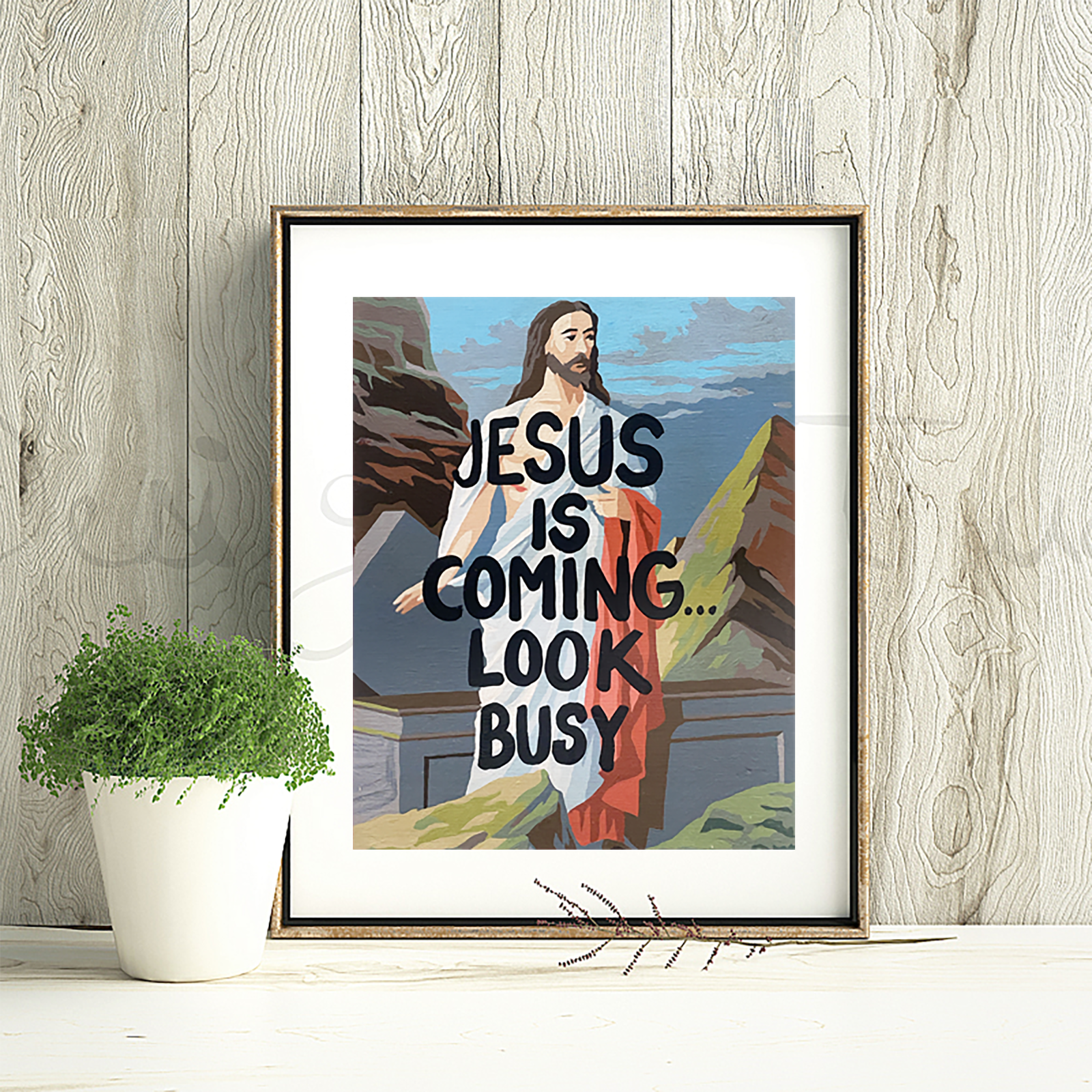 Framed artwork with a religious theme and text on a wooden wall.
