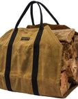Side view of the tan waxed canvas firewood carrier full of split logs on a white background