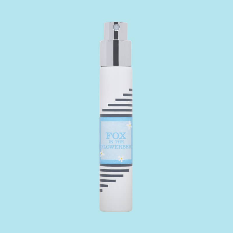White Imaginary Authors travel spray with a light blue Fox in the Flowerbed label on a pale blue background