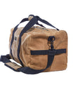 Tan waxed canvas duffel bag from an angle, showing the end panel and shoulder strap clip