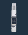 White Imaginary Authors travel spray with a navy Every Storm a Serenade label on a dark navy background