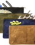 Four waxed canvas zipper tool bags holding cash, screwdrivers, wrenches and yellow wire nuts
