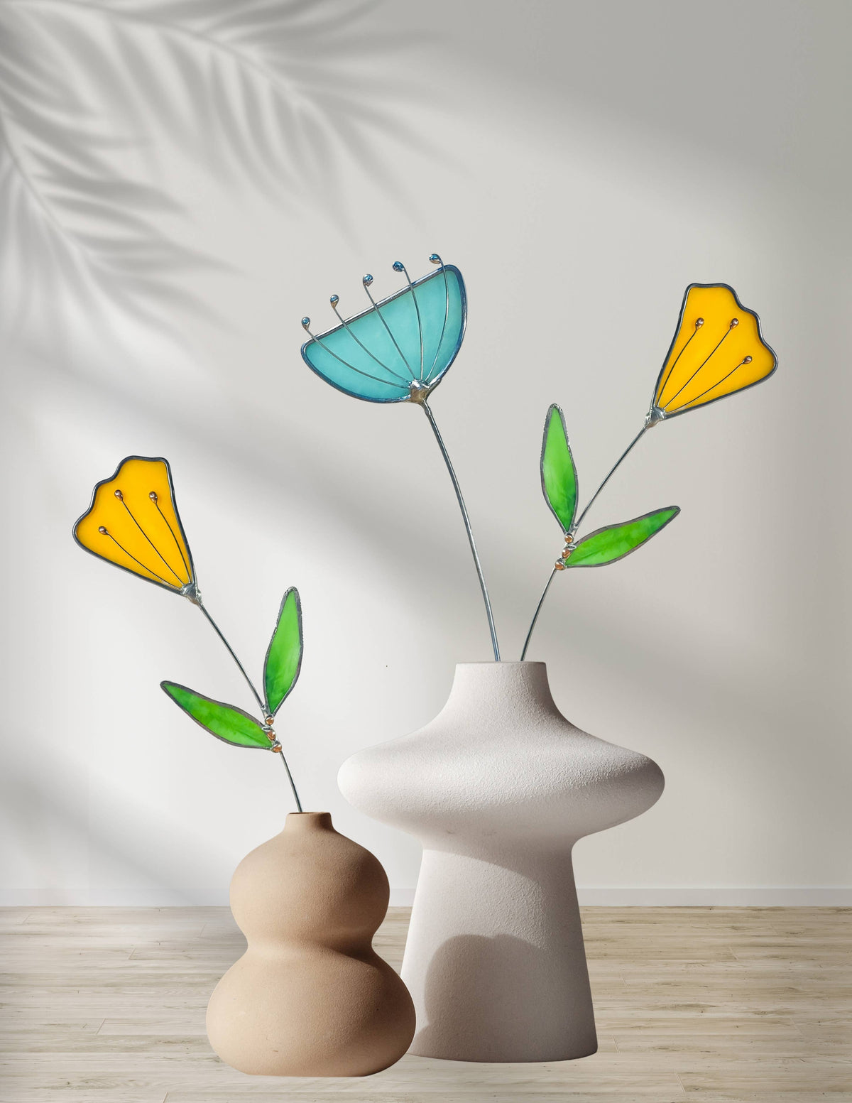 Stained glass yellow tulips and an aqua flower in beige sculptural vases