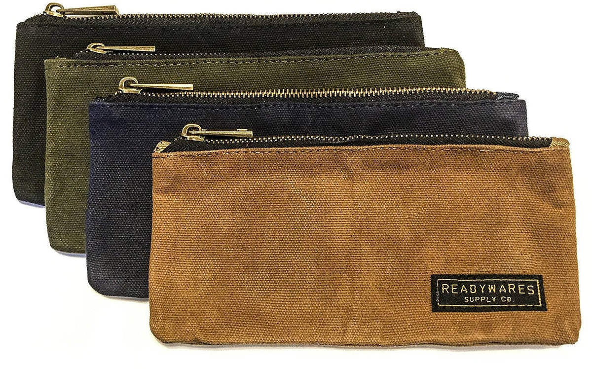 Black, olive, navy and tan zip pouches stacked with the Readywares label showing, on a white background