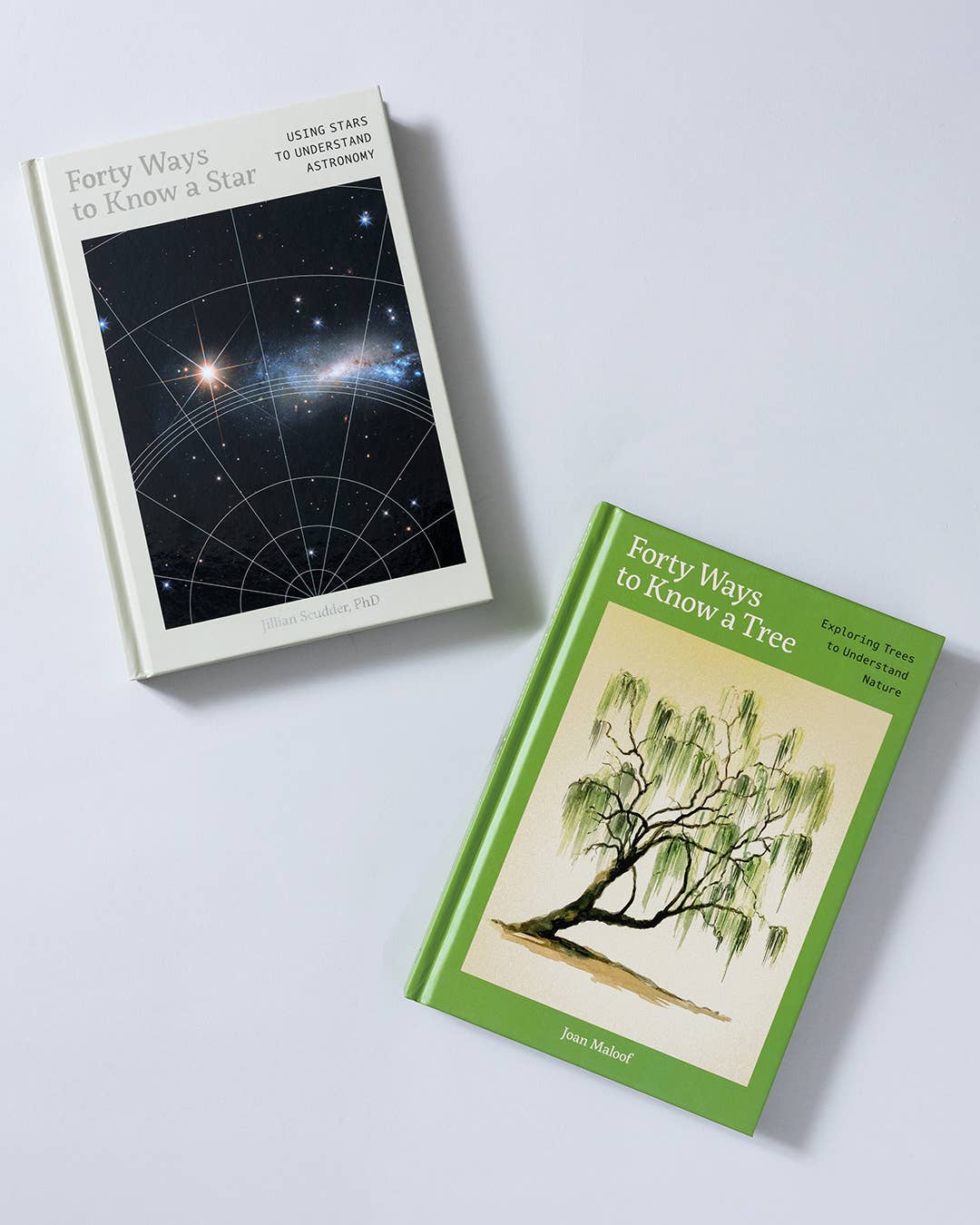 Forty Ways to Know a Tree and a dark starry companion book on a light background