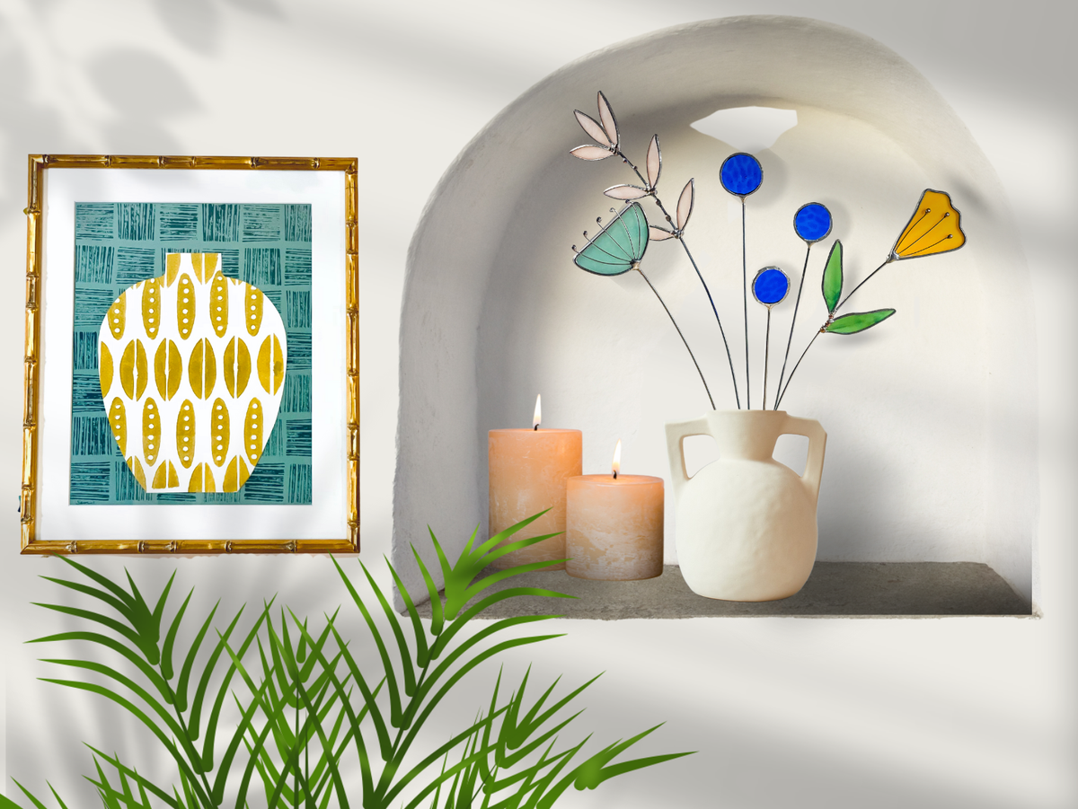 Stained glass flowers in a white jug in a wall niche with candles and a framed print