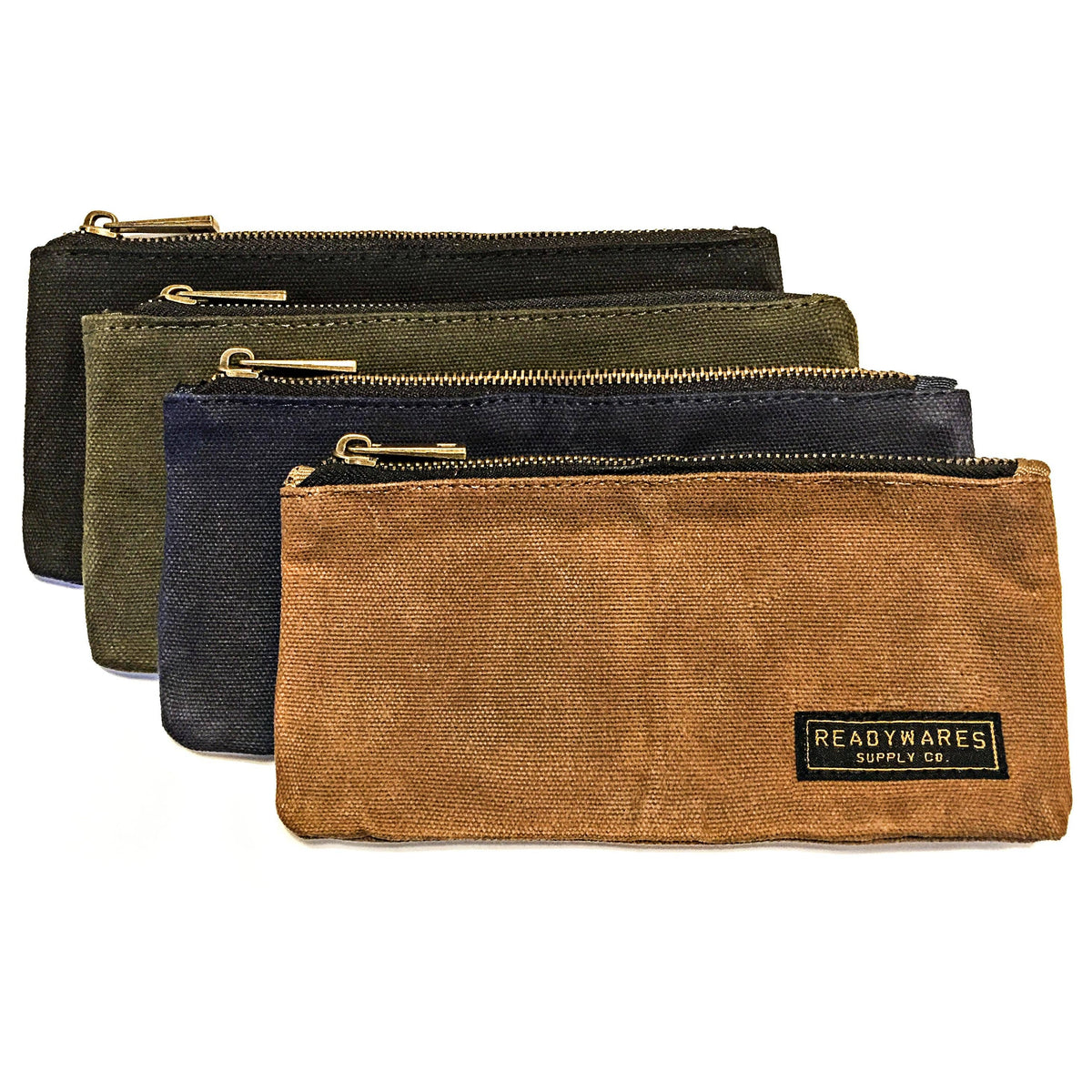 Four waxed canvas zip pouches in black, olive, navy and tan, layered on a white background