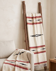 Cream Desert Mesa blanket draped over a wooden ladder beside a white chair