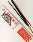 Clemeno White Tiger incense box with a tiger illustration beside dark bamboo incense sticks