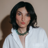 Model in a white shirt wearing the Hav Bauble Necklace in sea green