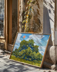Framed live oak print leaning in a sunny doorway with tree shadows