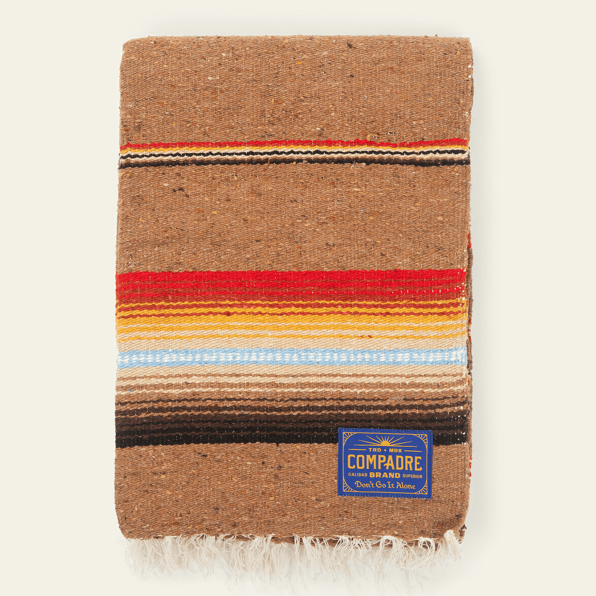 Camel brown sarape blanket with a band of red, light blue and dark brown stripes