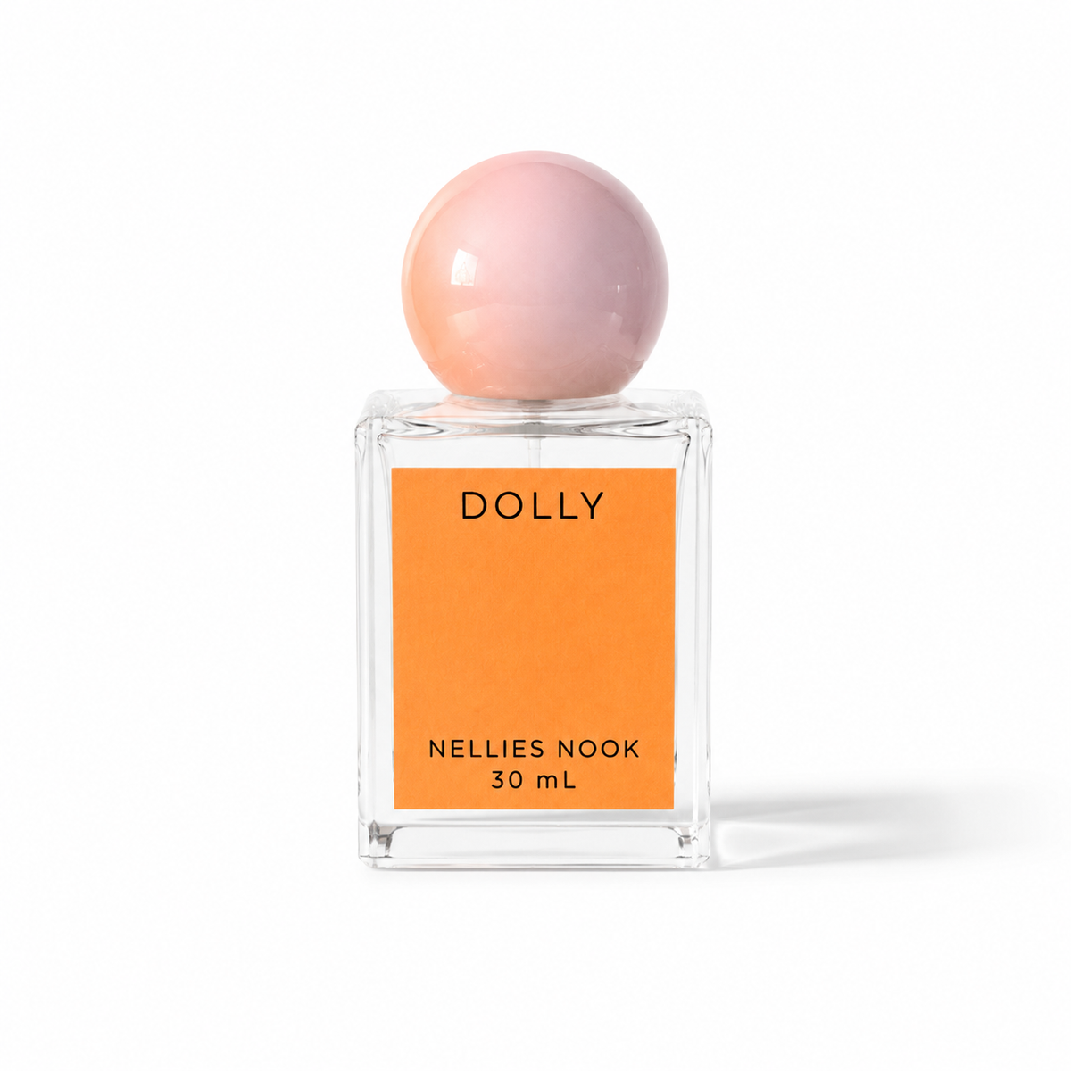 Dolly perfume bottle with a pink sphere cap and orange label on a white background